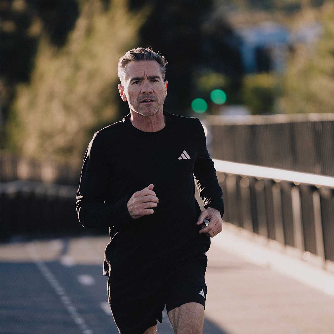 Male running across bridge
